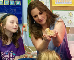 Mrs. Edwards (holding baby chick) and SHCC Student